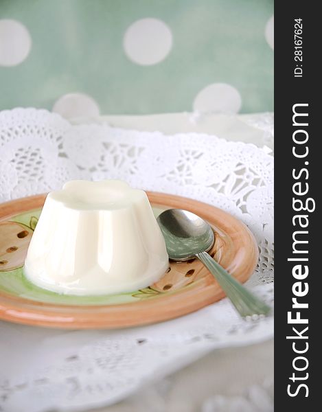 Sweet milk pudding on plate with polka dots background