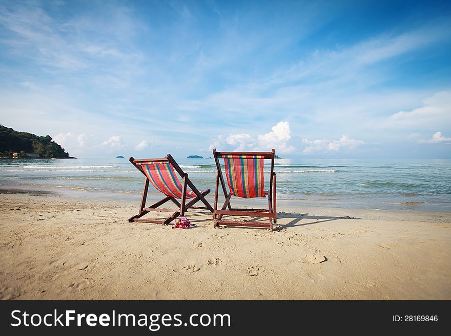 Two Bright Sun Loungers On The Beach.