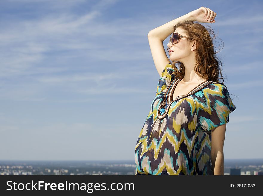 Beautiful Girl In Sunglasses On Background Blue Sky