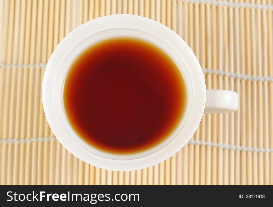 A cup of black tea on the white background