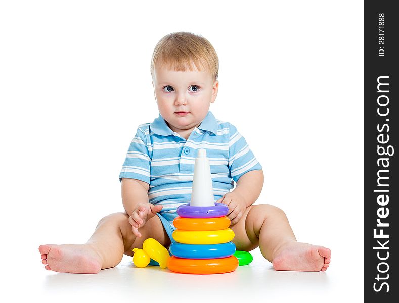 Funny baby boy playing with colorful toy on white