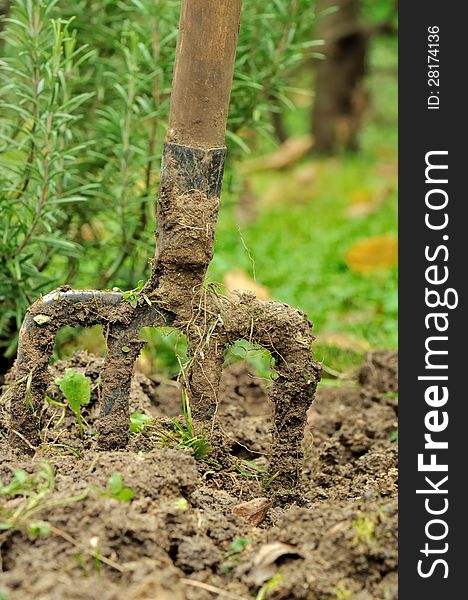 Closeup of a spade planted in garden soil. Closeup of a spade planted in garden soil