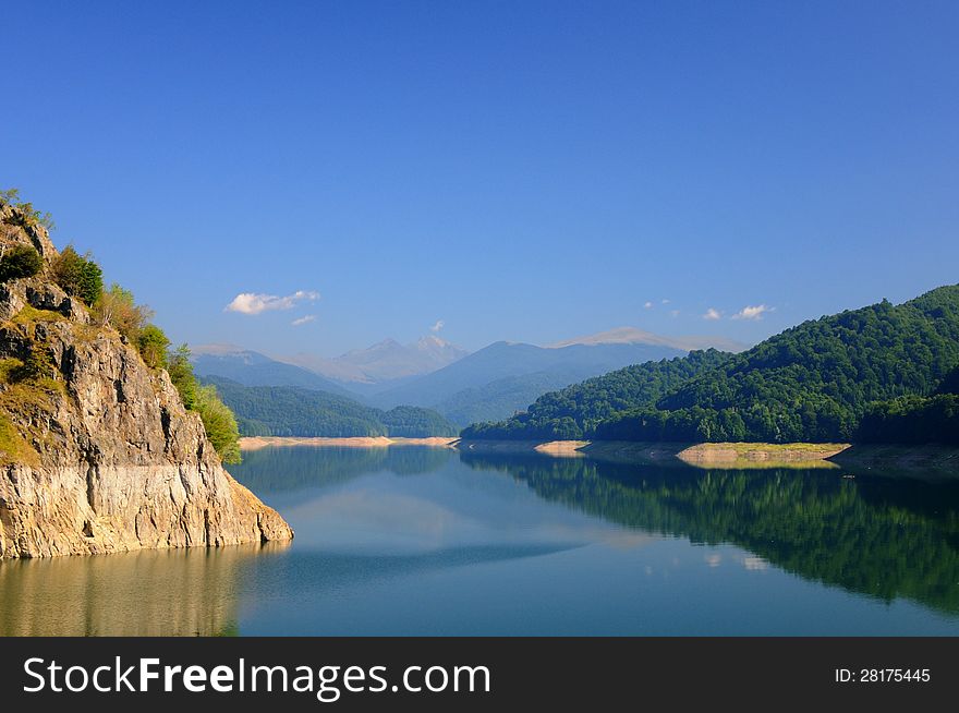Lake view with clear blue sky and green mountain forest. Lake view with clear blue sky and green mountain forest.