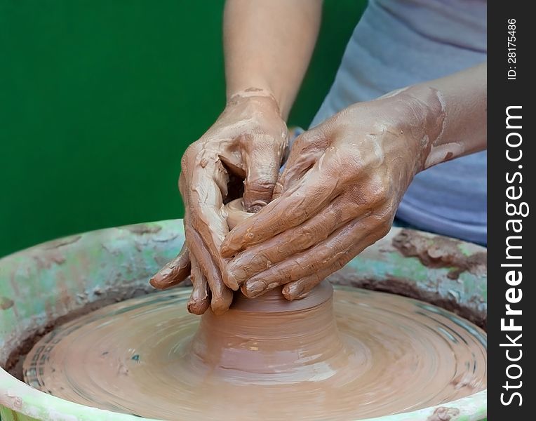 Potter makes the product on a potter's wheel. Potter makes the product on a potter's wheel