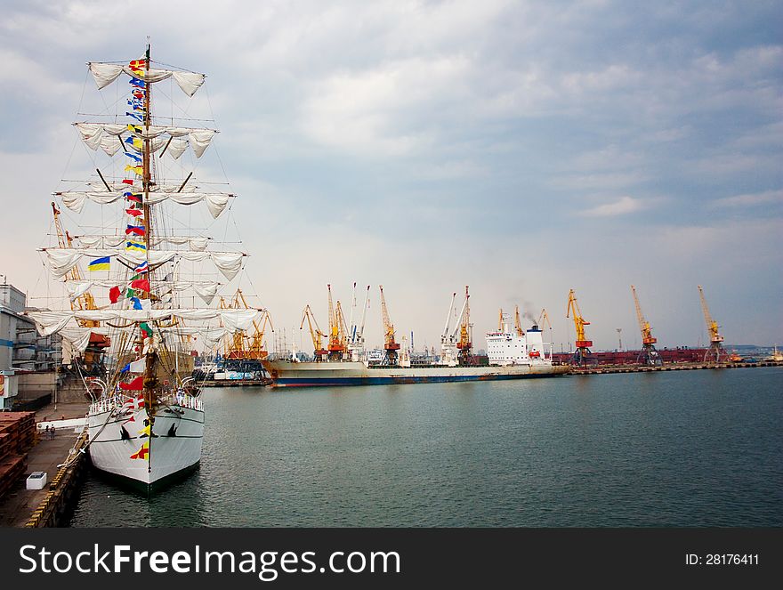 Sailing ship and a cargo ship docked in the port