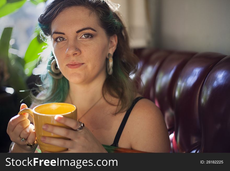 Young woman drinking coffee in a coffee house