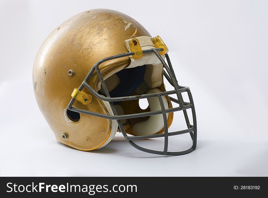 A gold american football helmet
