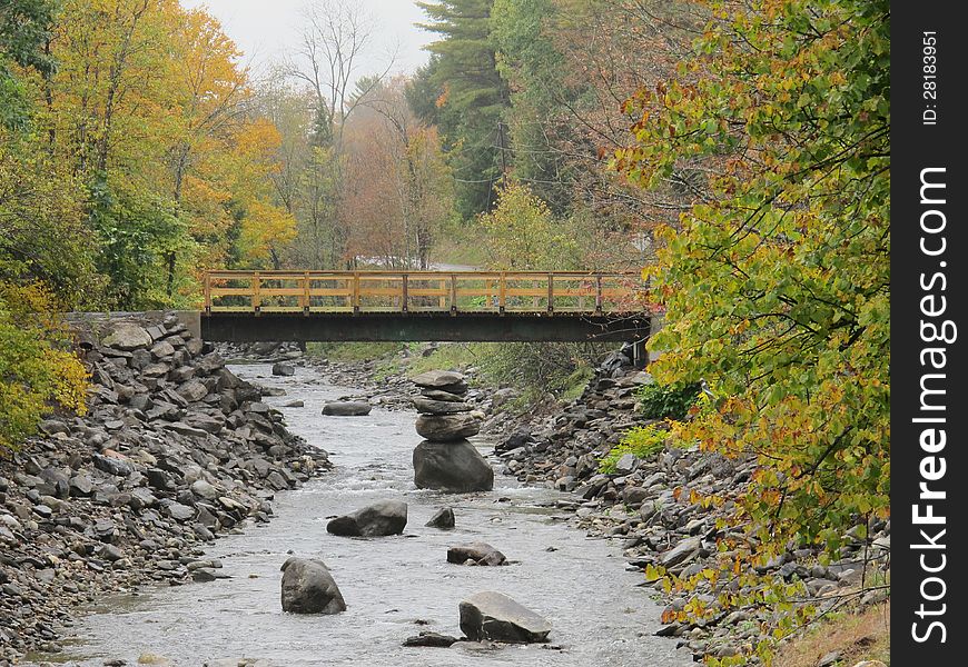 Ballanced rocks in river and bridge in Autumn on a rainy day. Ballanced rocks in river and bridge in Autumn on a rainy day.