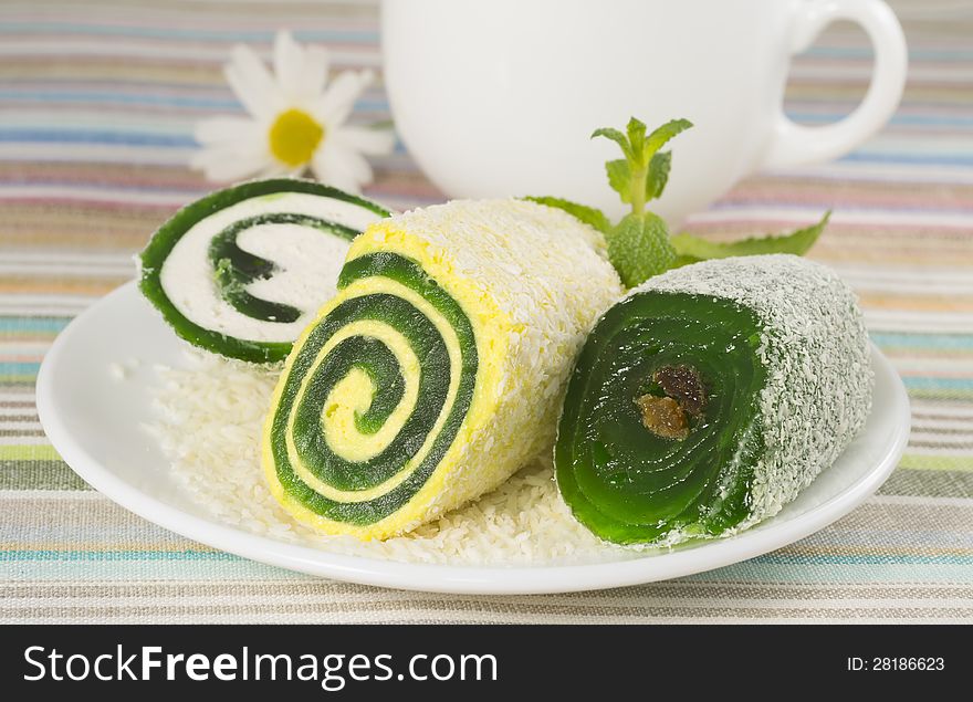 Sweet dessert in a plate with flower and cup, closeup