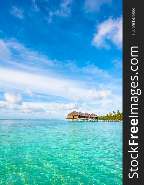 Tropical island beautiful landscape with emerald water, green trees and blue sky