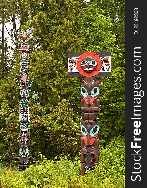 Pair of totem poles in Stanley Park, Vancouver, British Columbia. Pair of totem poles in Stanley Park, Vancouver, British Columbia