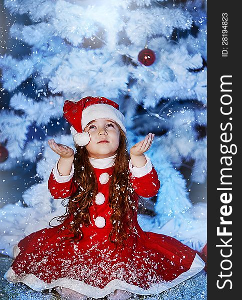 Little girl dressed as Santa Claus
