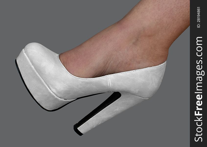 High-heeled bridal shoes, isolated on gray background. High-heeled bridal shoes, isolated on gray background
