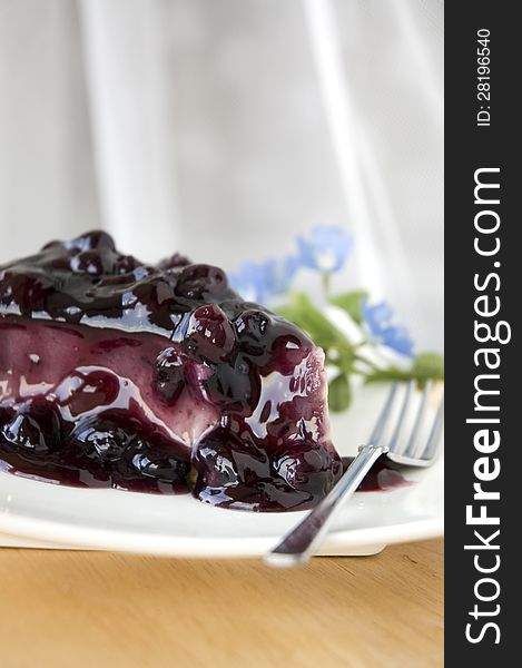 Blueberry cheesecake dessert on white plate