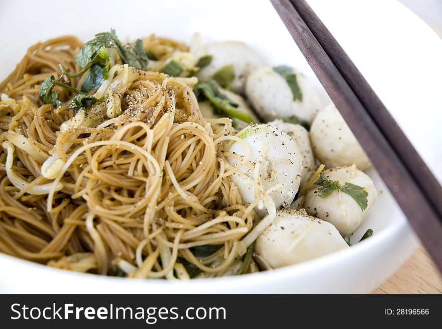 Close up asian noodle with meatball in white bowl