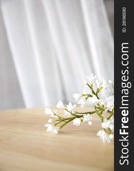 Pretty white artificial flowers on table