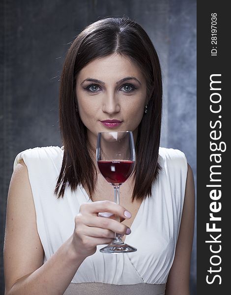 Attractive woman tasting red wine. Attractive woman tasting red wine