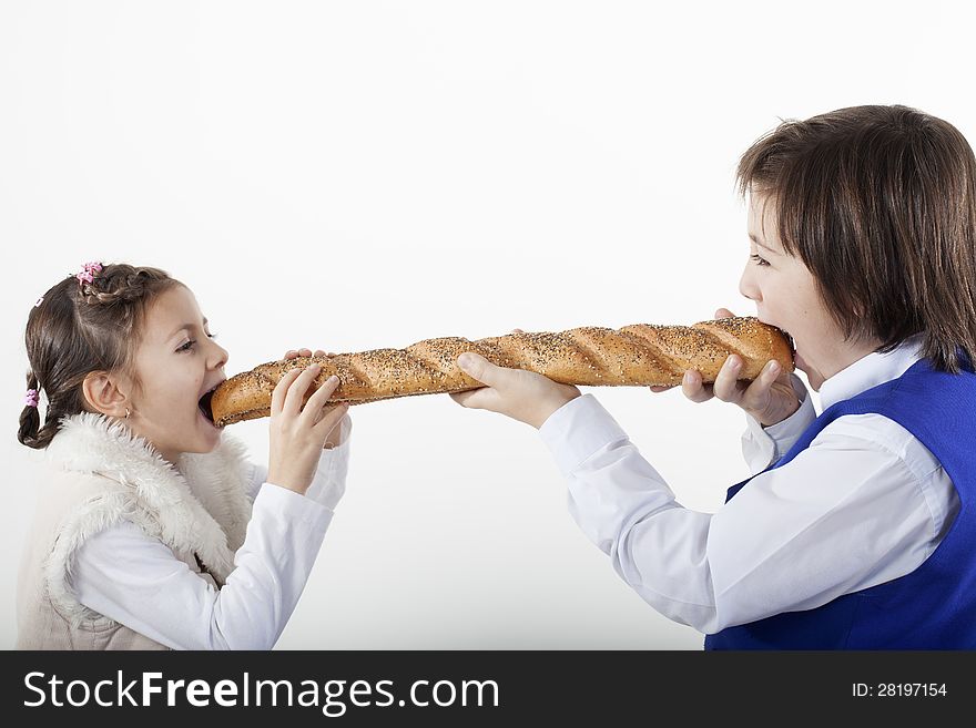 Two white kids sharing french baguette. Two white kids sharing french baguette