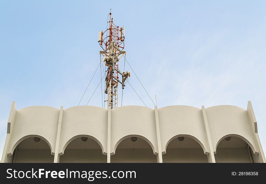 Telecommunication tower is on the top of a building