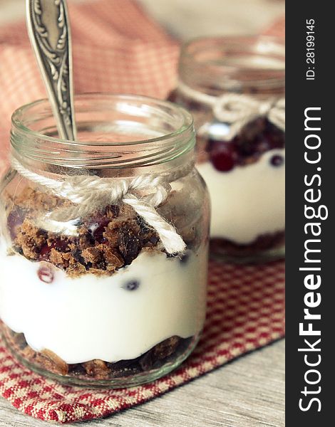 Cream cheese dessert with chocolate, cookies and cherry in a jar. Cream cheese dessert with chocolate, cookies and cherry in a jar