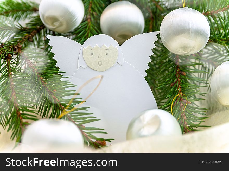 Christmas card with paper angel, balls and spruce twig