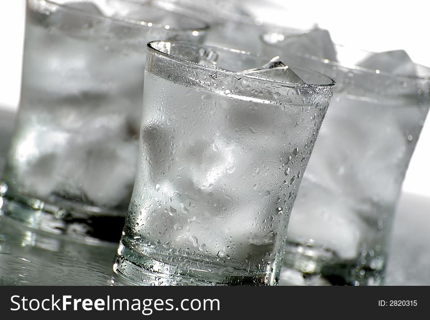 Glass of fresh water with ice close up