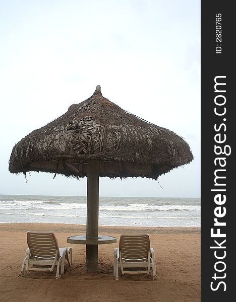 Deckchair on a tropical beach with sky and white sand