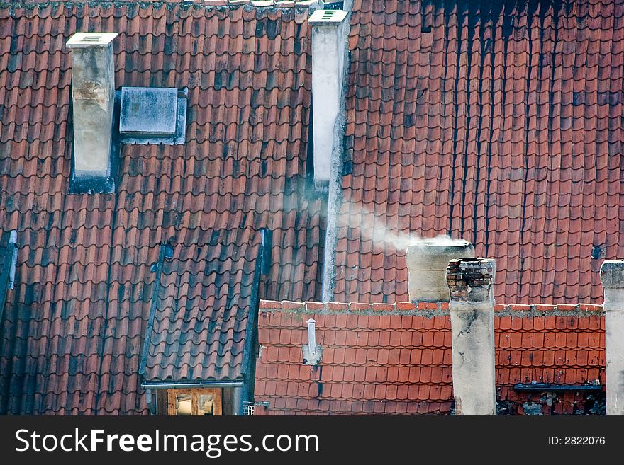 Roofs with red tiling, pipes, a wind. Roofs with red tiling, pipes, a wind