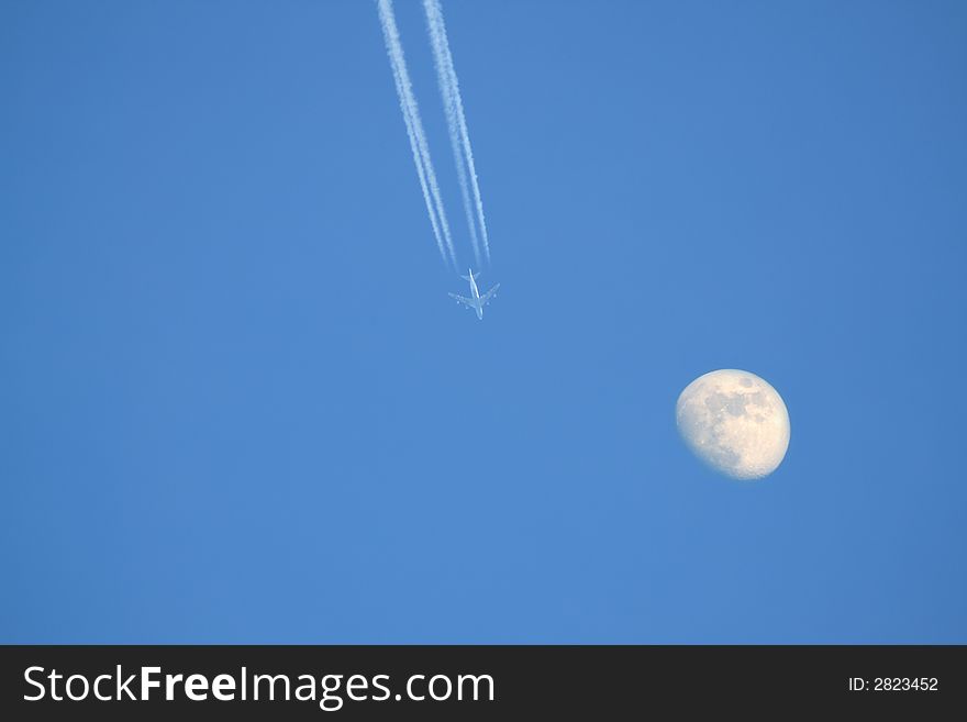 Shot of a plane high in the skies with moon. Shot of a plane high in the skies with moon