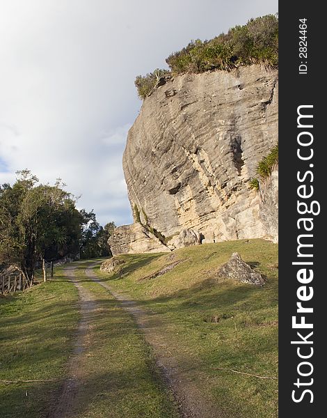 A country road winds around wind eroded limestone cliffs. A country road winds around wind eroded limestone cliffs