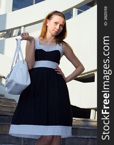 Businees woman with bag on modern building