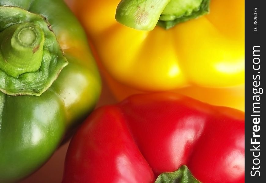 A closeup on three bell pepper: red, yellow, green. A closeup on three bell pepper: red, yellow, green