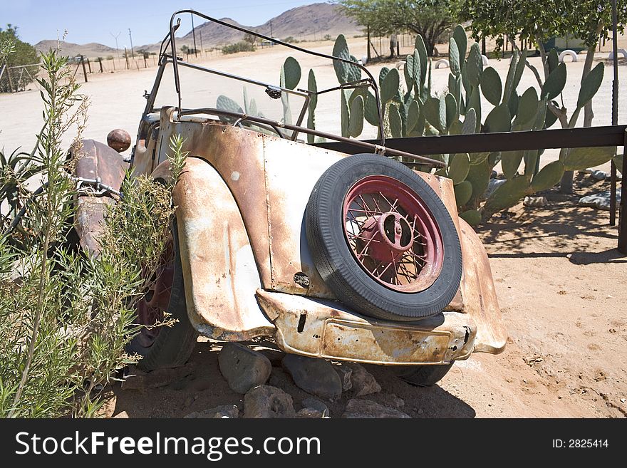 Old metal parts, rusty car on desert