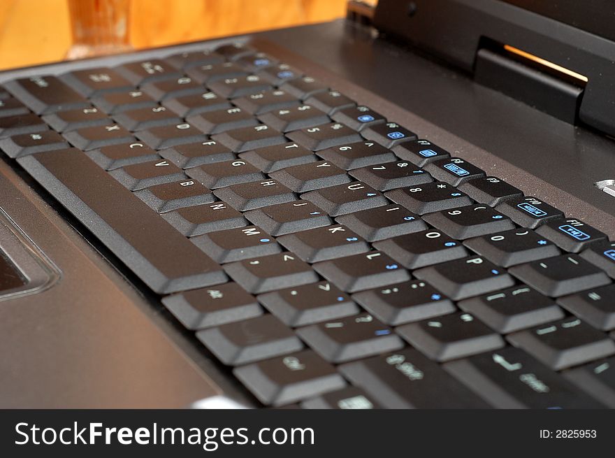 Close-up of silver laptop with black keyboard. Close-up of silver laptop with black keyboard