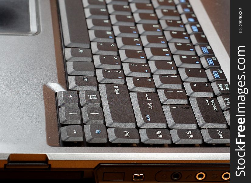 Close-up of silver laptop with black keyboard. Close-up of silver laptop with black keyboard