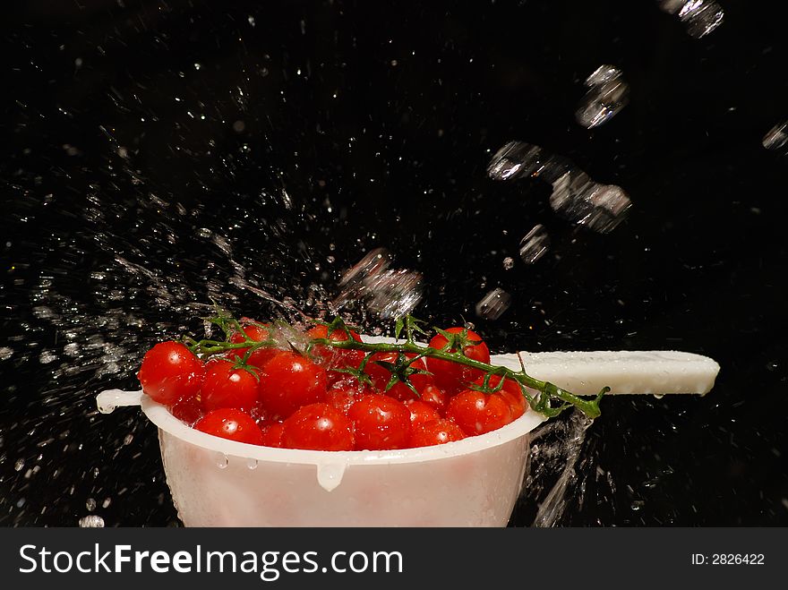 A bowl of tasty cherry tomatos with water drops. A bowl of tasty cherry tomatos with water drops