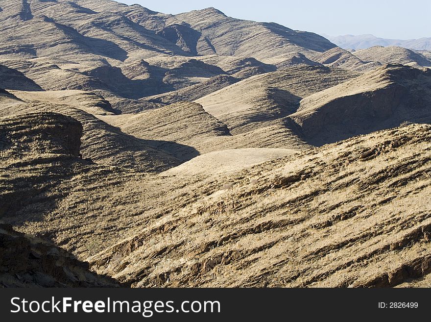 Desert landscape in Africa Namibia, golden rocks, clear blue sky