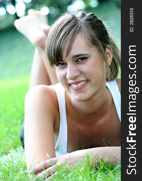 Woman lying on grass, smiling