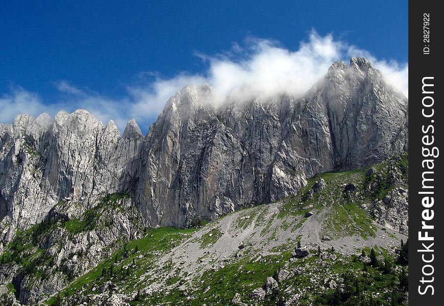 Gastlosen mountain range is part of the Pre-Alps Mountains in the Fribourg canton of Switzerland. The image is focusing on the Sattelspitzen segment, with the highest peak named Ruedigenspitze (2124m), surprising it with the head-in-the-clouds. Gastlosen is the paradise of the best rock-climbers in the area, offering extremely dangerous and natural courses. Gastlosen mountain range is part of the Pre-Alps Mountains in the Fribourg canton of Switzerland. The image is focusing on the Sattelspitzen segment, with the highest peak named Ruedigenspitze (2124m), surprising it with the head-in-the-clouds. Gastlosen is the paradise of the best rock-climbers in the area, offering extremely dangerous and natural courses.