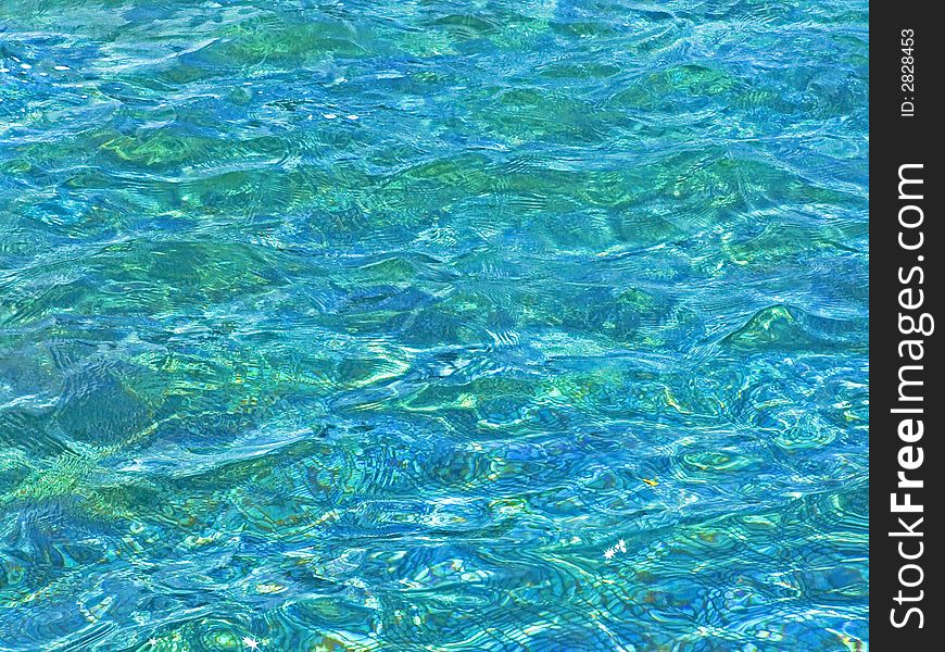 Clear blue pool water surface with waves