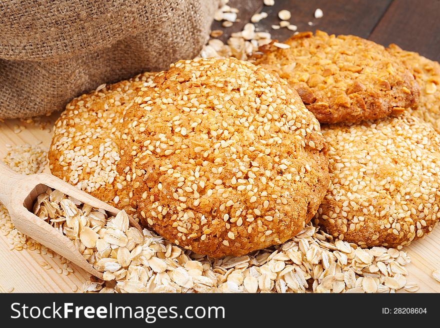 Cookies with sesame seeds on wooden board