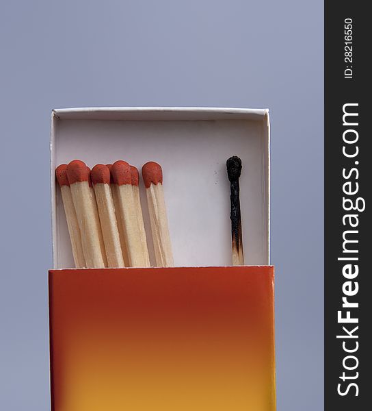 Matchbox with matches on gray