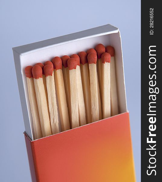 Matchbox with matches on gray