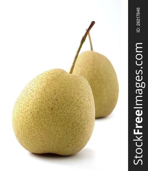 Closeup of two juicy organic pears on white