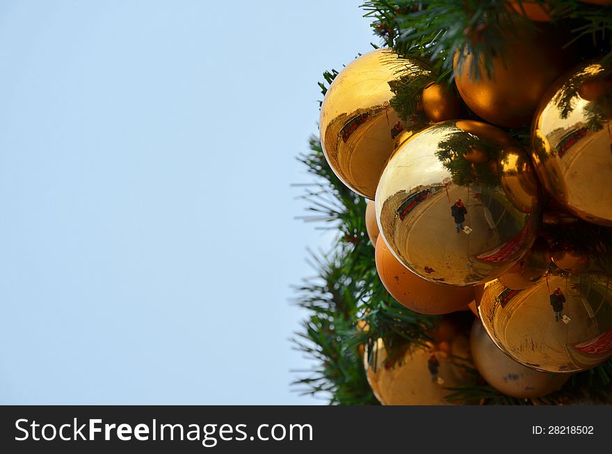 Closeup of golden Christmas globes with copyspace on left