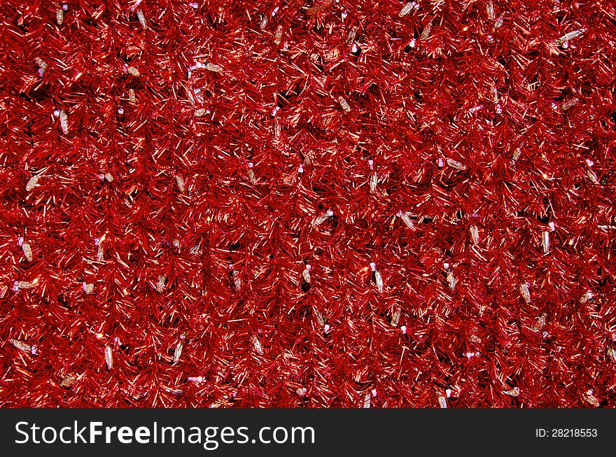 Red tinsel Christmas decoration background texture with white bulbs