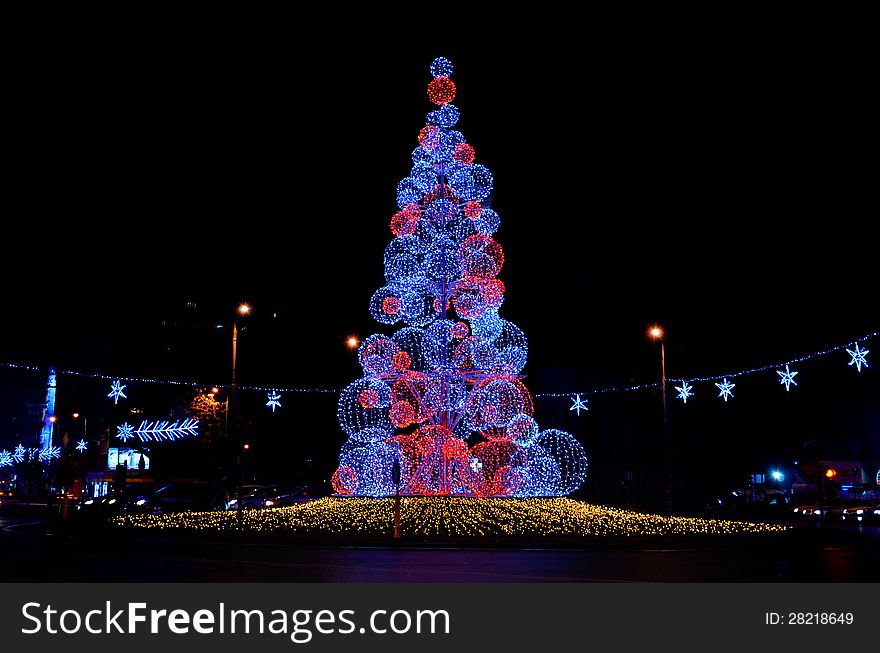 Glowing christmas tree in a city square