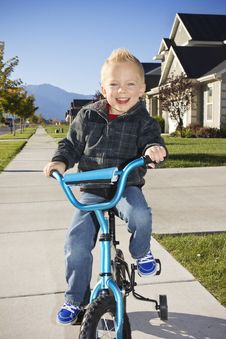 Little Boy Learning To Ride A Bike With Training Wheels Royalty Free Stock Image Little Boy Learning To Ride A Bike With Training Wheels Royalty Free Stock Image