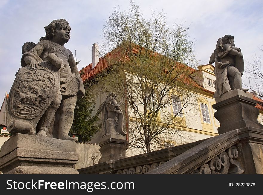 Stone sculptures of a angels on a background of medieval of Prague, Czech Republic. Stone sculptures of a angels on a background of medieval of Prague, Czech Republic