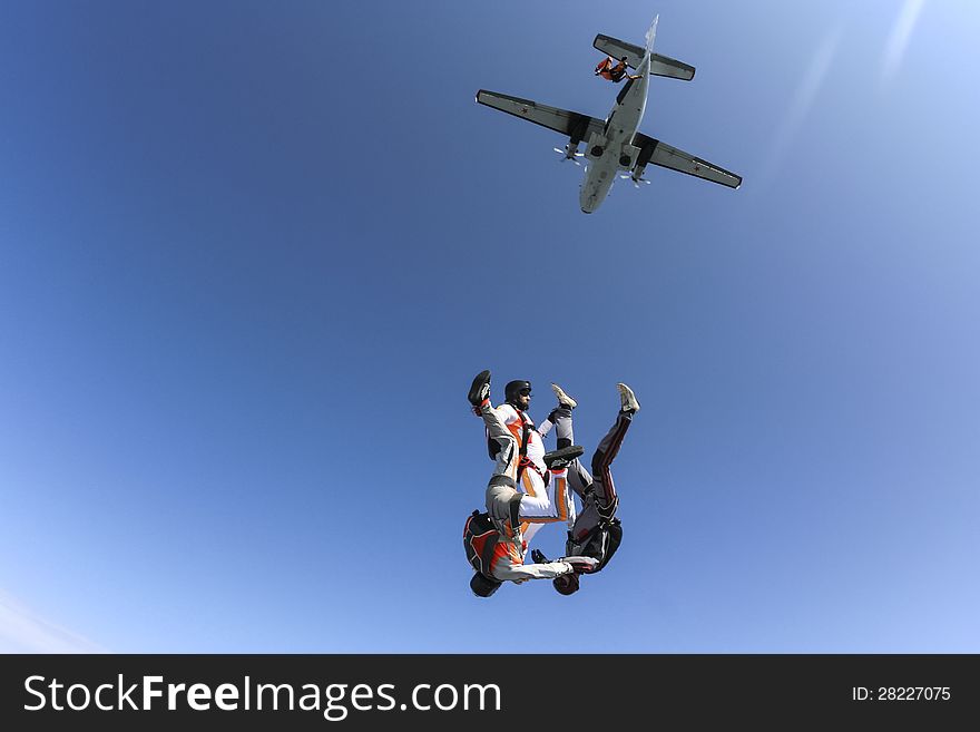 A group of paratroopers jumping out of an airplane. A group of paratroopers jumping out of an airplane.